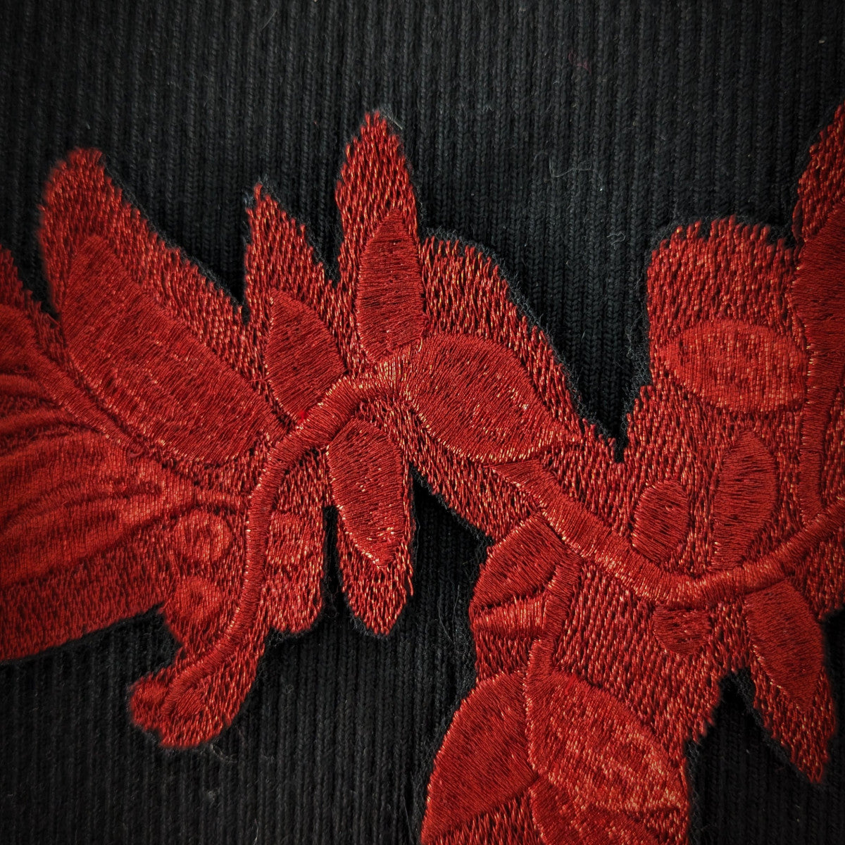 D&G red lurex embroidered floral patch, 23cm, on a black fabric background.