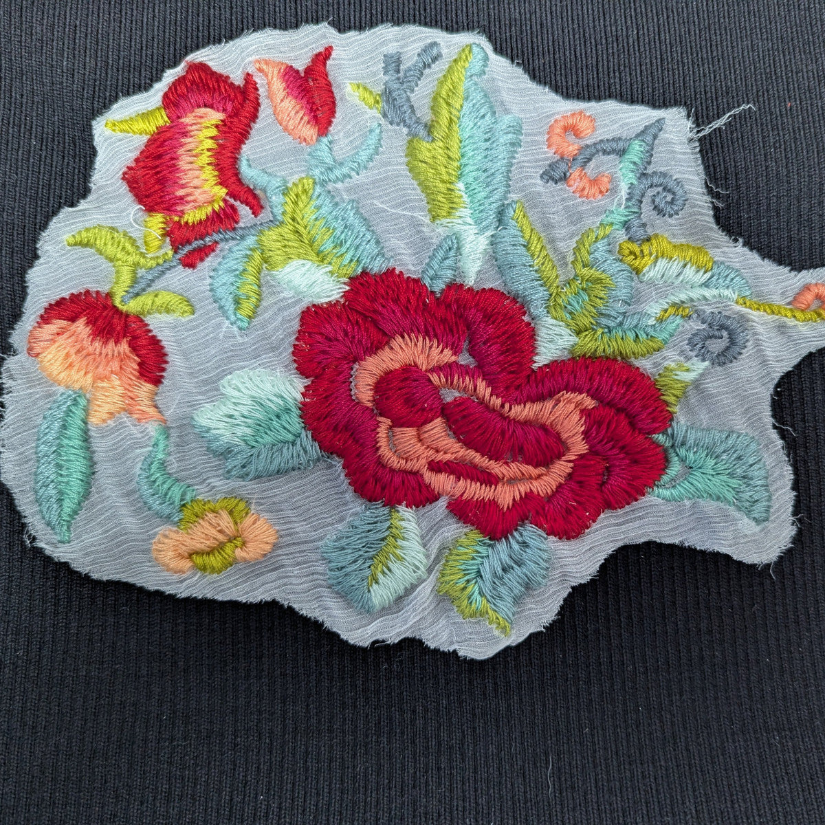 Gucci-style XXL patch with intricate red, pink, green, and blue rose embroidery on a sheer fabric base.