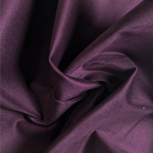 Luxurious aubergine elastic velvet denim fabric, deadstock, showcasing its soft, velvety texture and elegant drape.