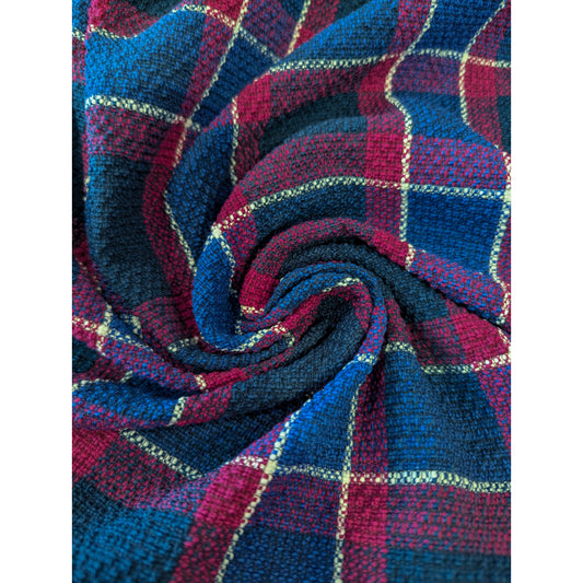 Deadstock tweed cotton fabric, blue and magenta plaid with thin white lines, swirled.