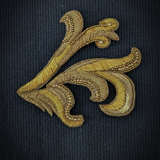 D&G gold metallic embroidered ornamental patch, 14cm, with beads and sequins on dark fabric.