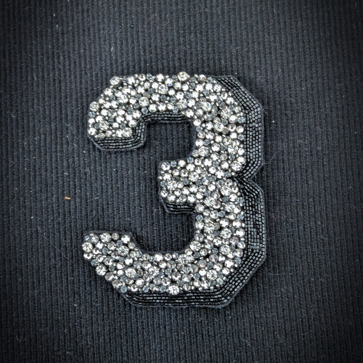 Embroidered D&G "3" patch, 10cm, with sparkling silver beads on a black fabric background.
