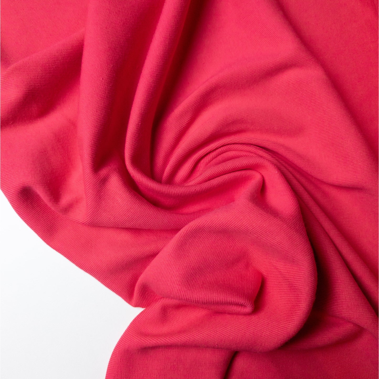 Fuchsia pink ribbed knit deadstock fabric, 105 cm wide, draped with soft folds.