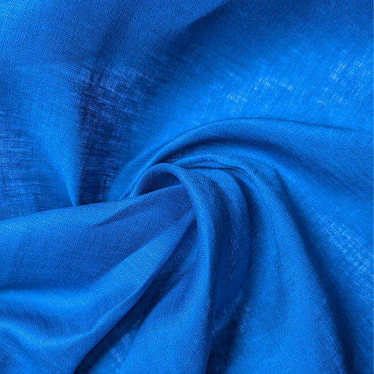 Deadstock chinose blue linen fabric, unicolor with a subtle sheen, draped in soft folds.