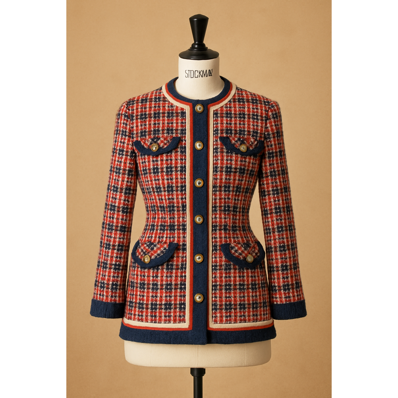 Red, blue, and white tweed jacket with gold buttons and navy trim, displayed on a mannequin.
