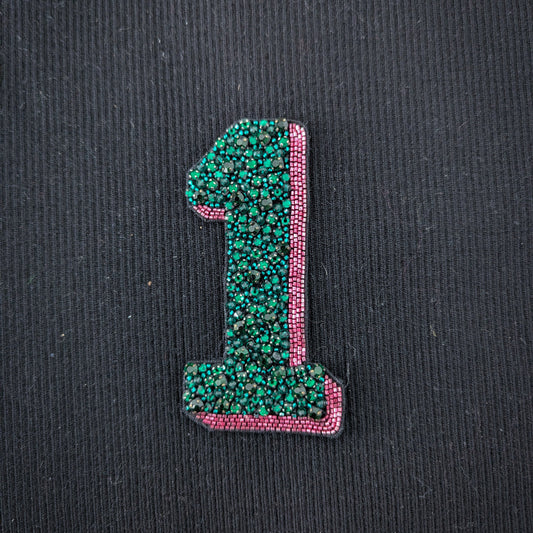Embroidered D&G "1" patch, 10cm, with green beads and pink pearl trim on black fabric.