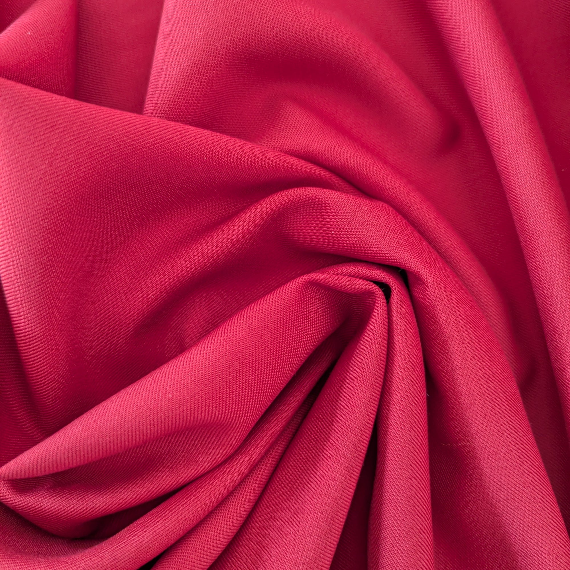 G*cci deadstock soft red wool fabric, 145cm wide, with light stretch, draped to show its smooth texture.