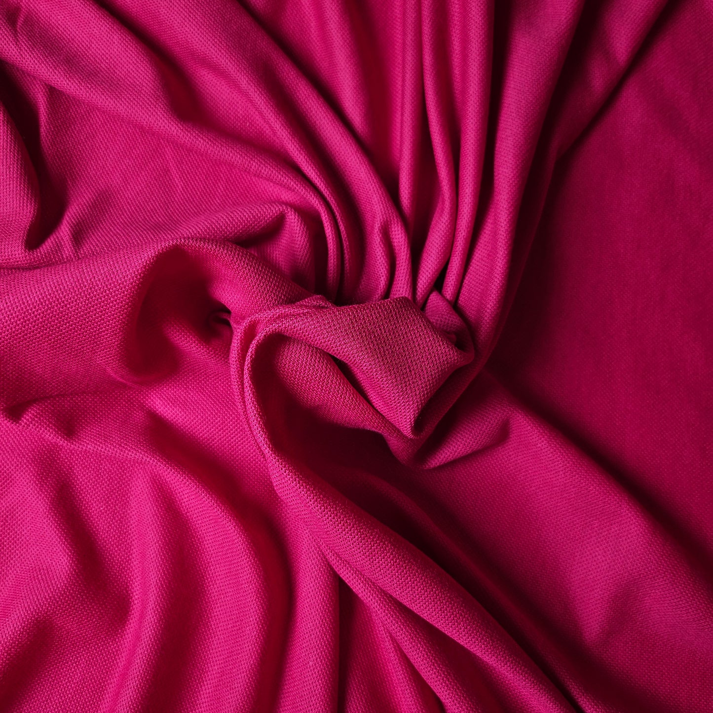 Vibrant fuchsia cotton-cashmere pique fabric, deadstock designer material, 190 cm wide, with a textured weave.