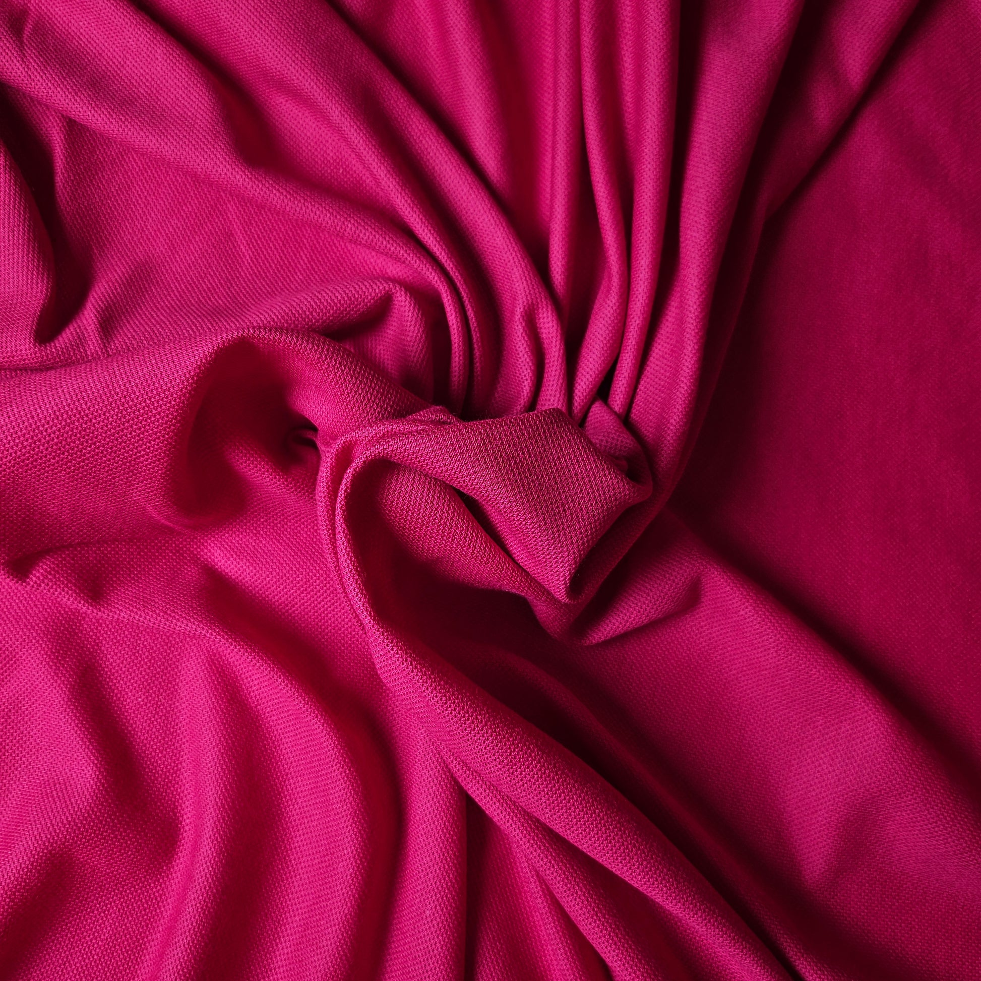 Vibrant fuchsia cotton-cashmere pique fabric, deadstock designer material, 190 cm wide, with a textured weave.