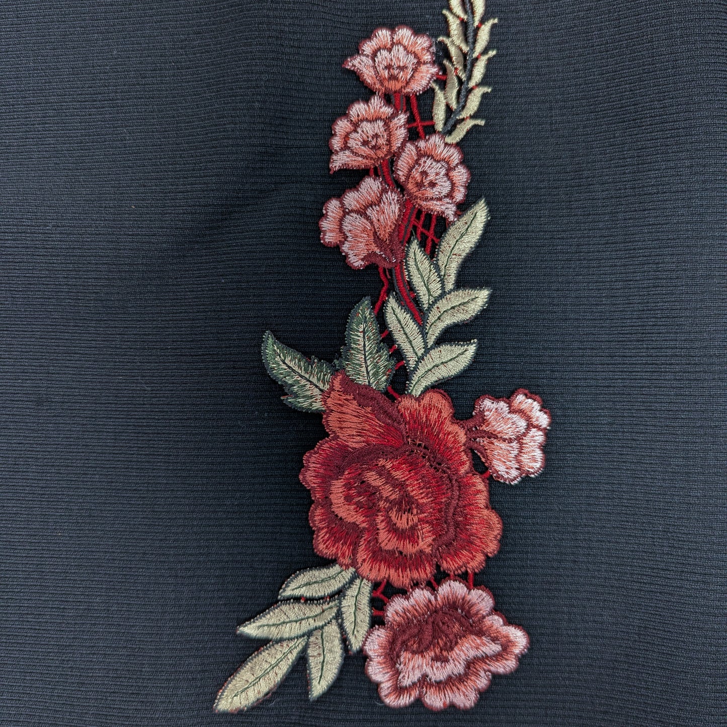 Gucci XXL embroidered rose patch, 24cm, with red and pink flowers and green leaves on dark fabric.