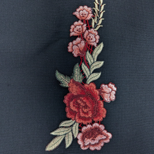 Gucci XXL embroidered rose patch, 24cm, with red and pink flowers and green leaves on dark fabric.