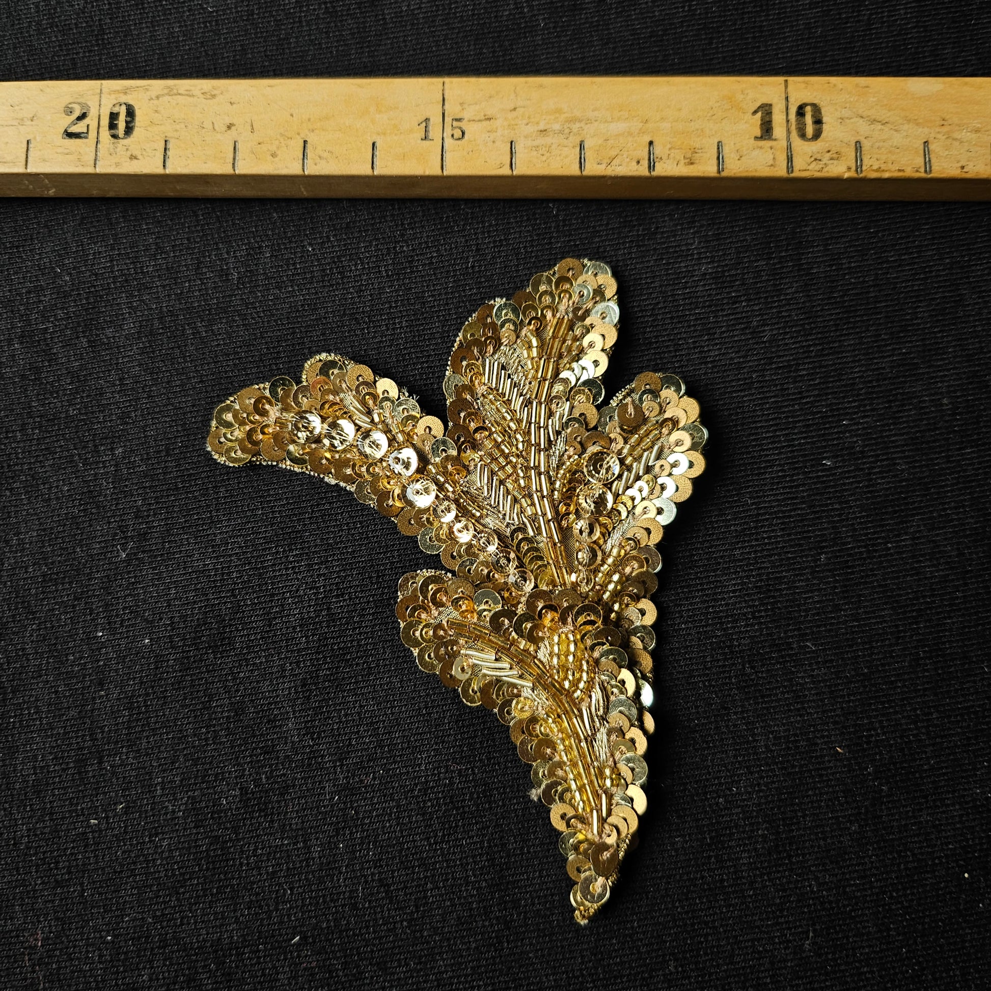 D&G gold sequin and embroidery leaf patch, 7x9 cm, on black fabric.