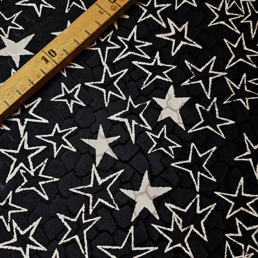 Black and off-white YSL deadstock silk jacquard fabric with star pattern and ruler.