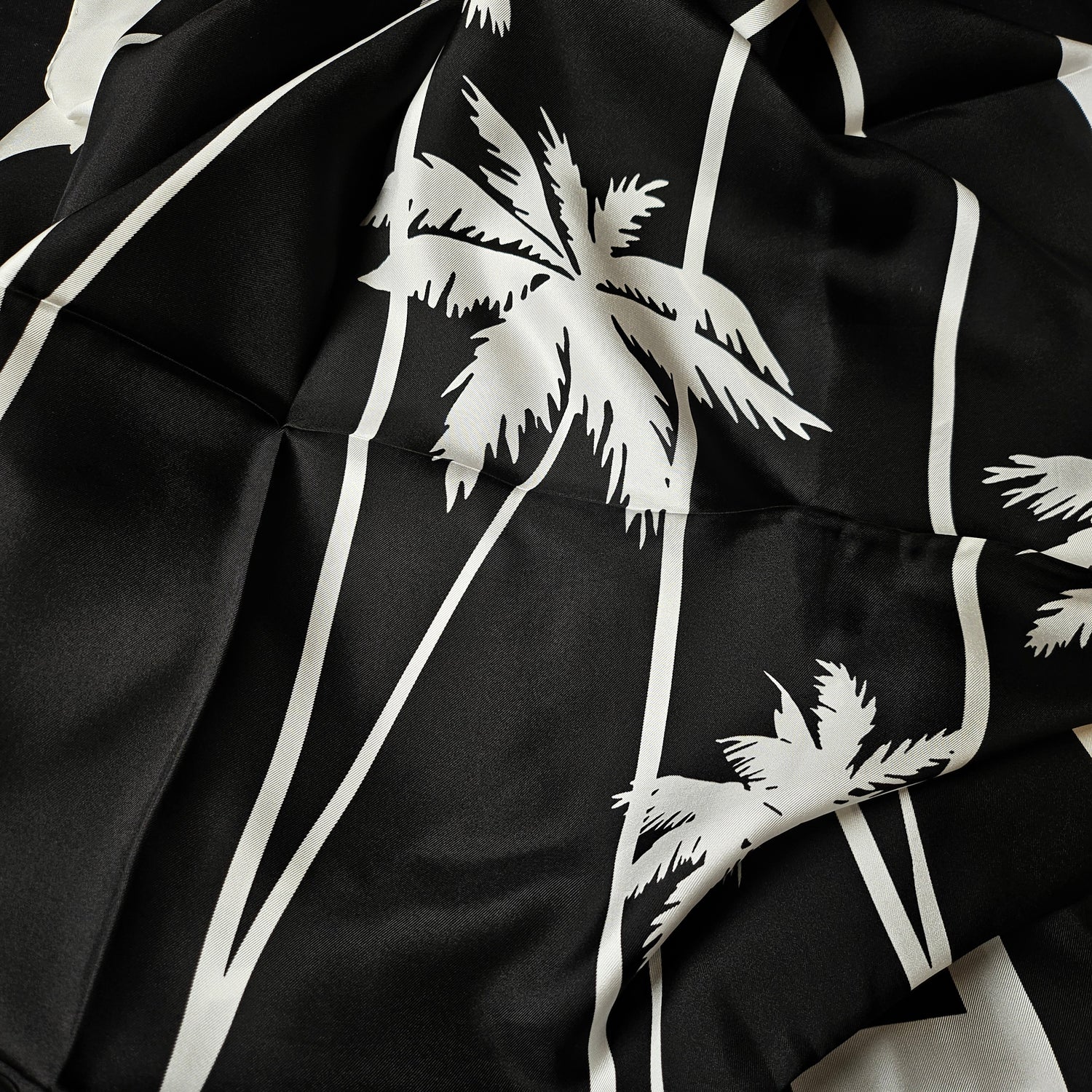Black silk scarf with white palm tree and stripe design, 90x90 cm.