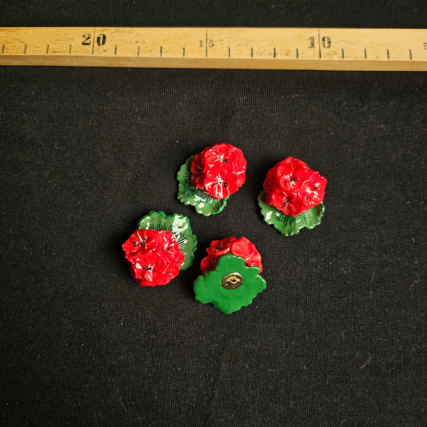 Four D&G deadstock plastic buttons, 4x4cm, featuring glossy red flowers with green leaves on a black background.
