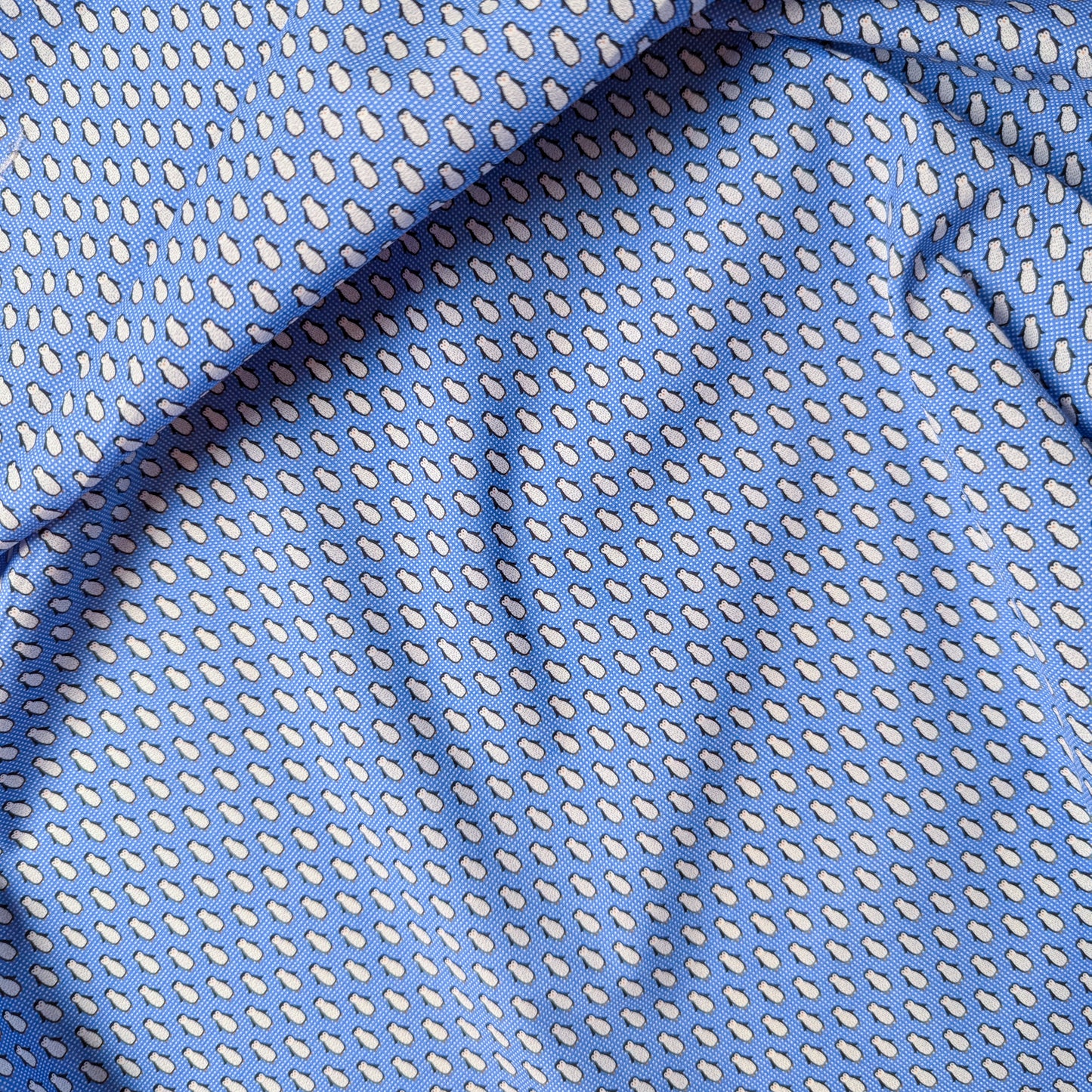 Blue deadstock cotton poplin fabric with a small white teardrop pattern.
