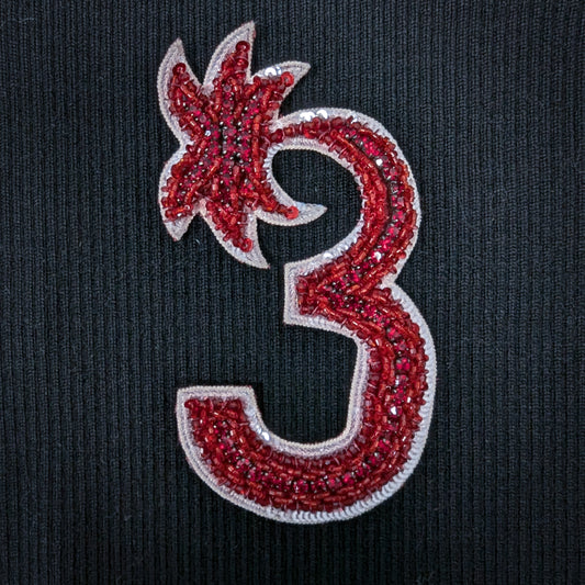 D&G embroidered red beaded number 3 patch with three pearls, 13cm high, on black fabric.