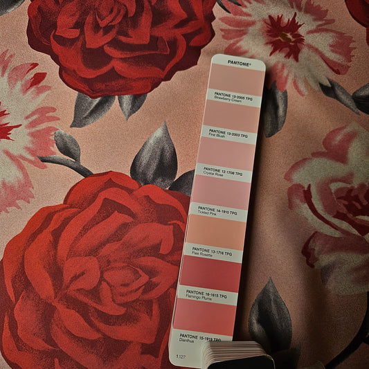 Deadstock Ferragamo silk twill fabric with large red and pink floral print, next to a Pantone color swatch.