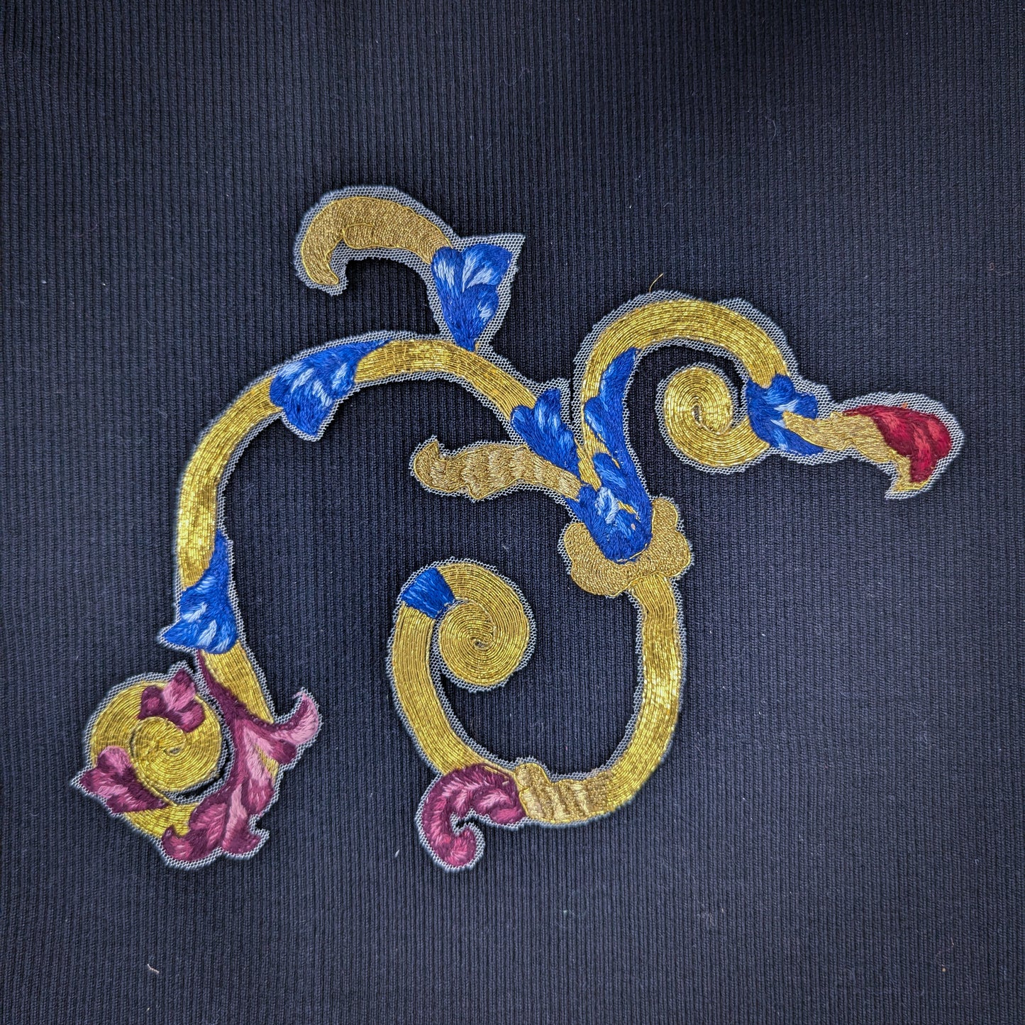 D&G gold embroidery patch with blue, red, and pink floral accents on fine tulle, 30x15 cm.