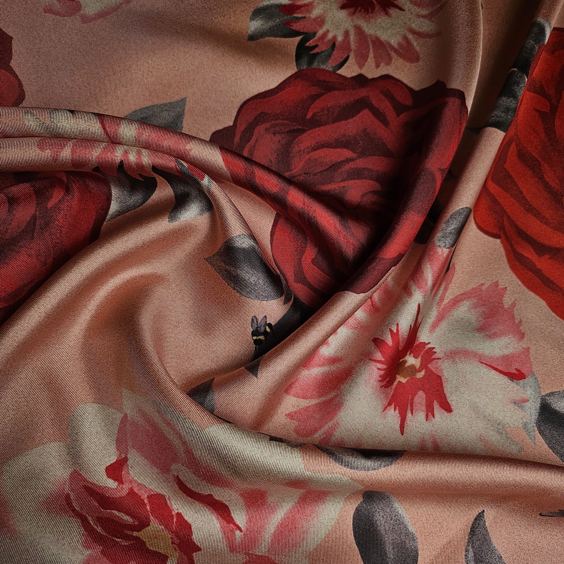 Deadstock Ferragamo silk twill fabric, 50cm, with large red and pink floral print on a peach background.