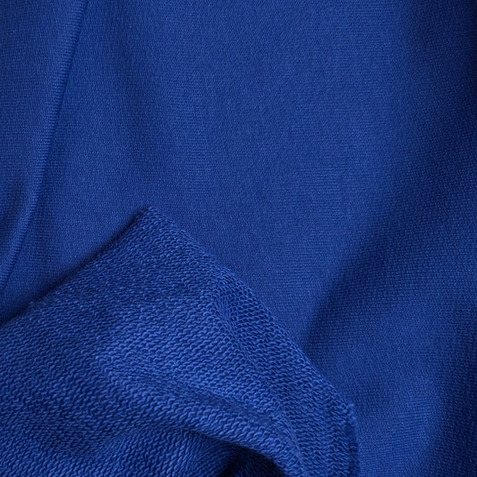 Deadstock G*cci royal blue sweatstoff fabric, showing smooth face and looped back.