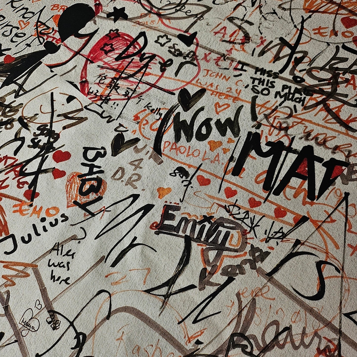 Deadstock B*rberry sweat panel in Whisper White, covered with black, red, and brown graffiti-style text and hearts.