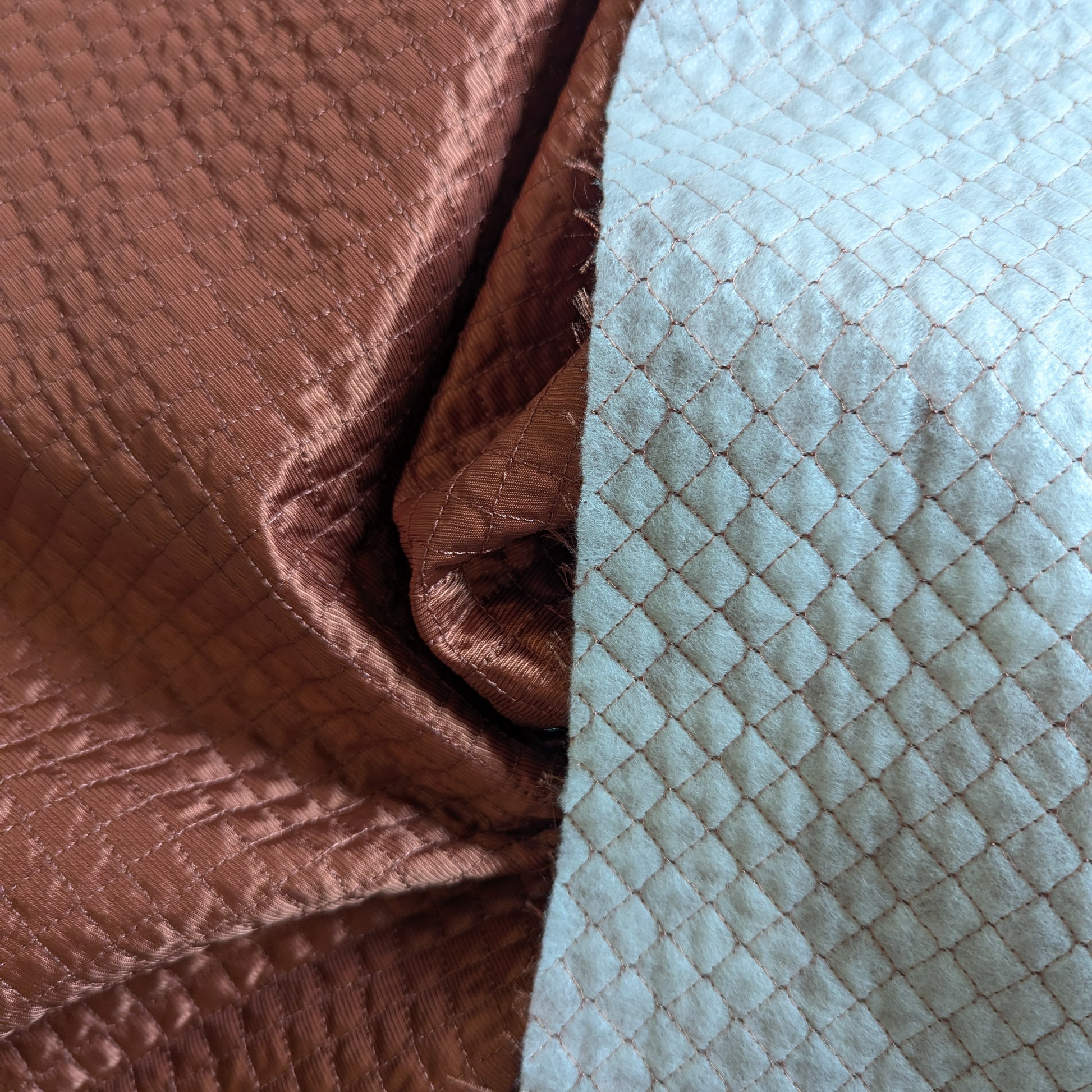 Luxurious Etruscan Red G*cci deadstock quilted fabric, lightly padded with a diamond pattern, showing both sides.