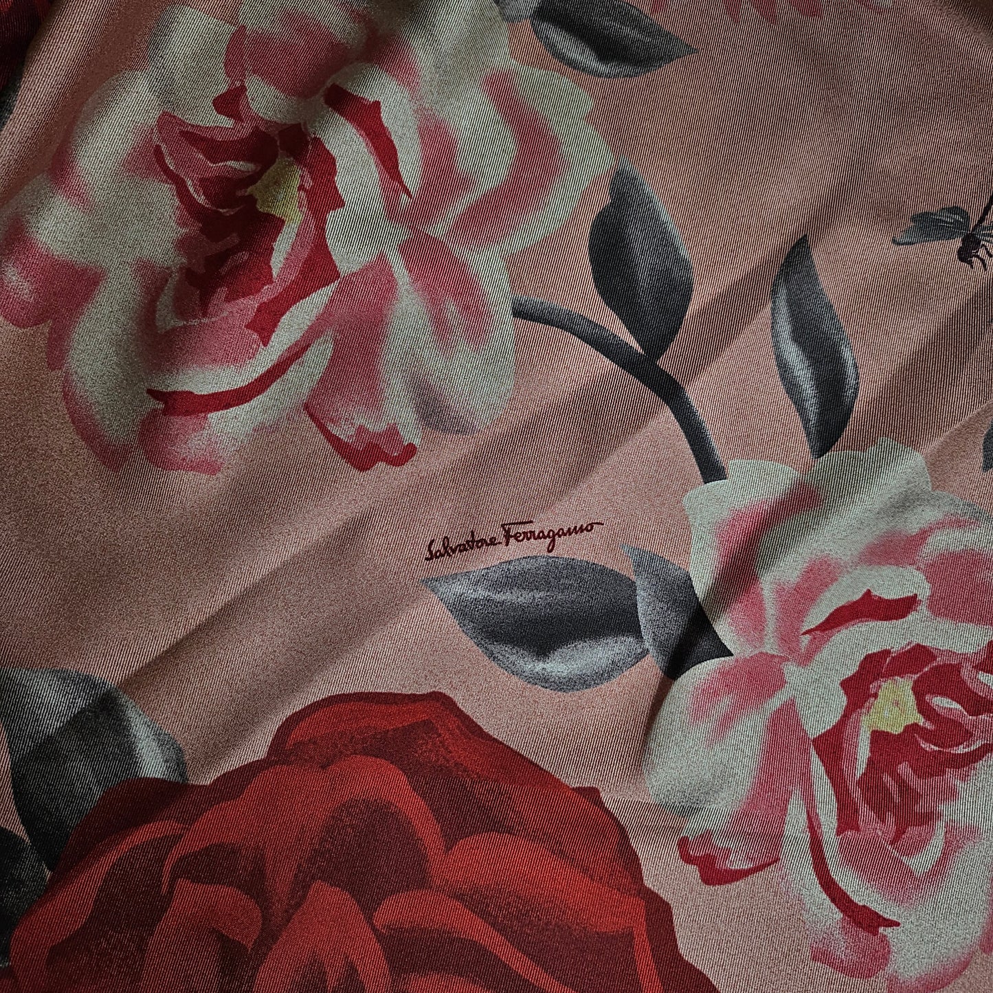 Pink silk twill fabric with red and white floral print, featuring "Salvatore Ferragamo" signature.