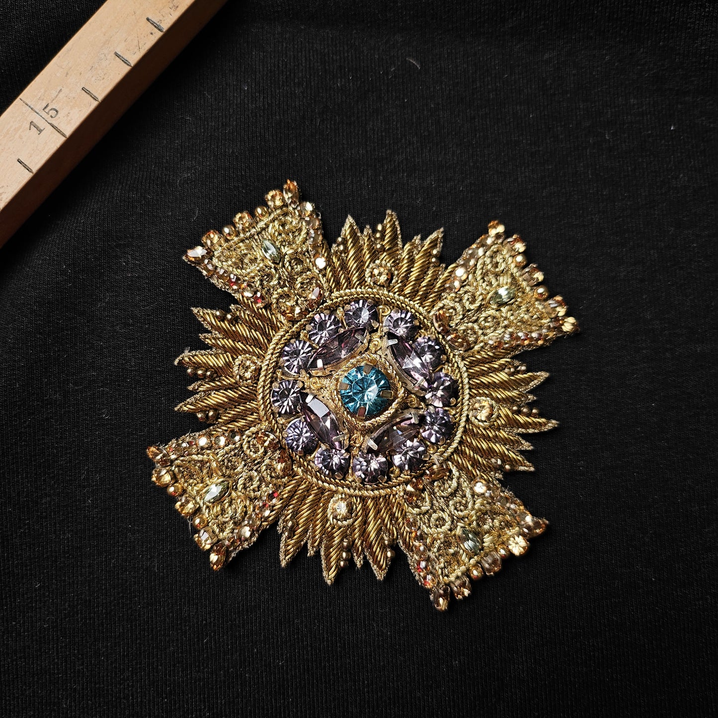 D&G gold metallic embroidered patch with purple and blue crystal embellishments, 9x9cm.