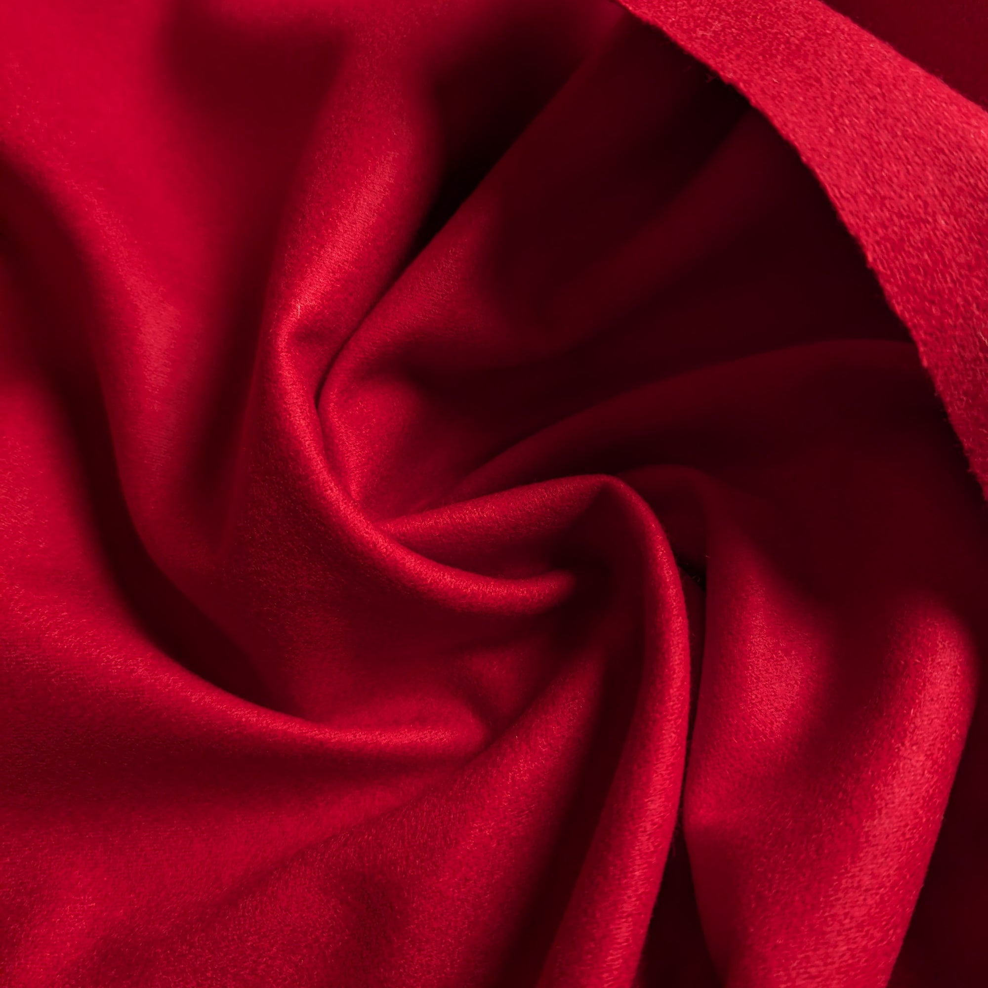 Rich red melange designer wool fabric, soft and structured, draped in flowing folds.
