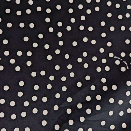 Black D&G cotton deadstock fabric with scattered white polka dots, ideal for linings.
