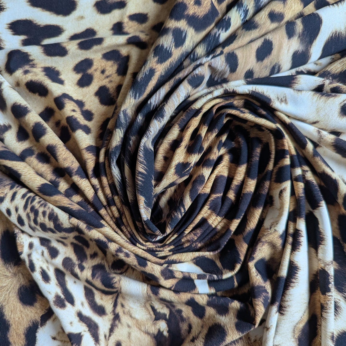 Swirled C*avalli deadstock Lycra fabric in a natural brown and black leopard print design.