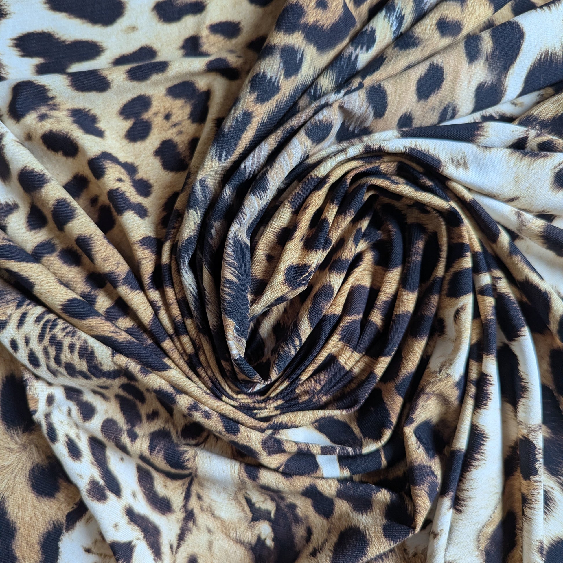 Swirled C*avalli deadstock Lycra fabric in a natural brown and black leopard print design.