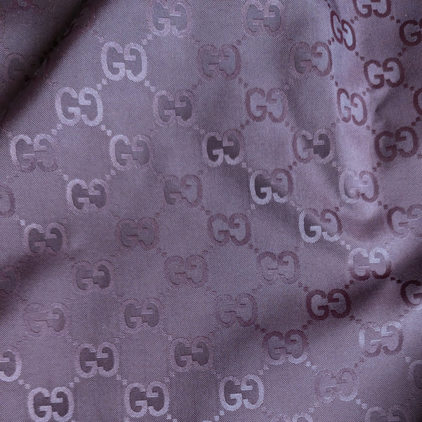 Bordeaux polyester deadstock fabric with a subtle, repeating G*cci monogram pattern.