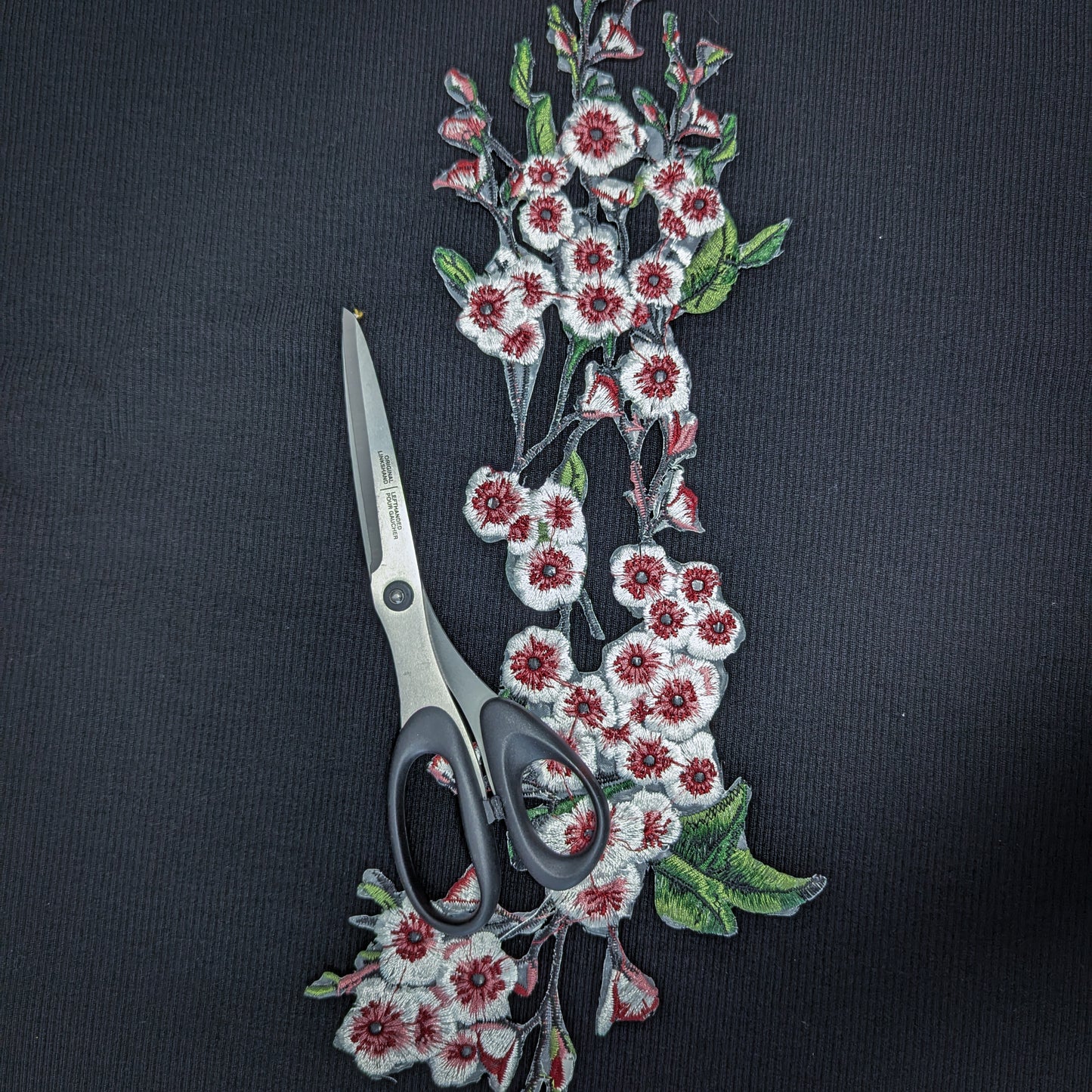 XXL G*cci knitted cherry blossom patch, 40cm, with red, white, and green embroidery on black fabric, beside scissors.