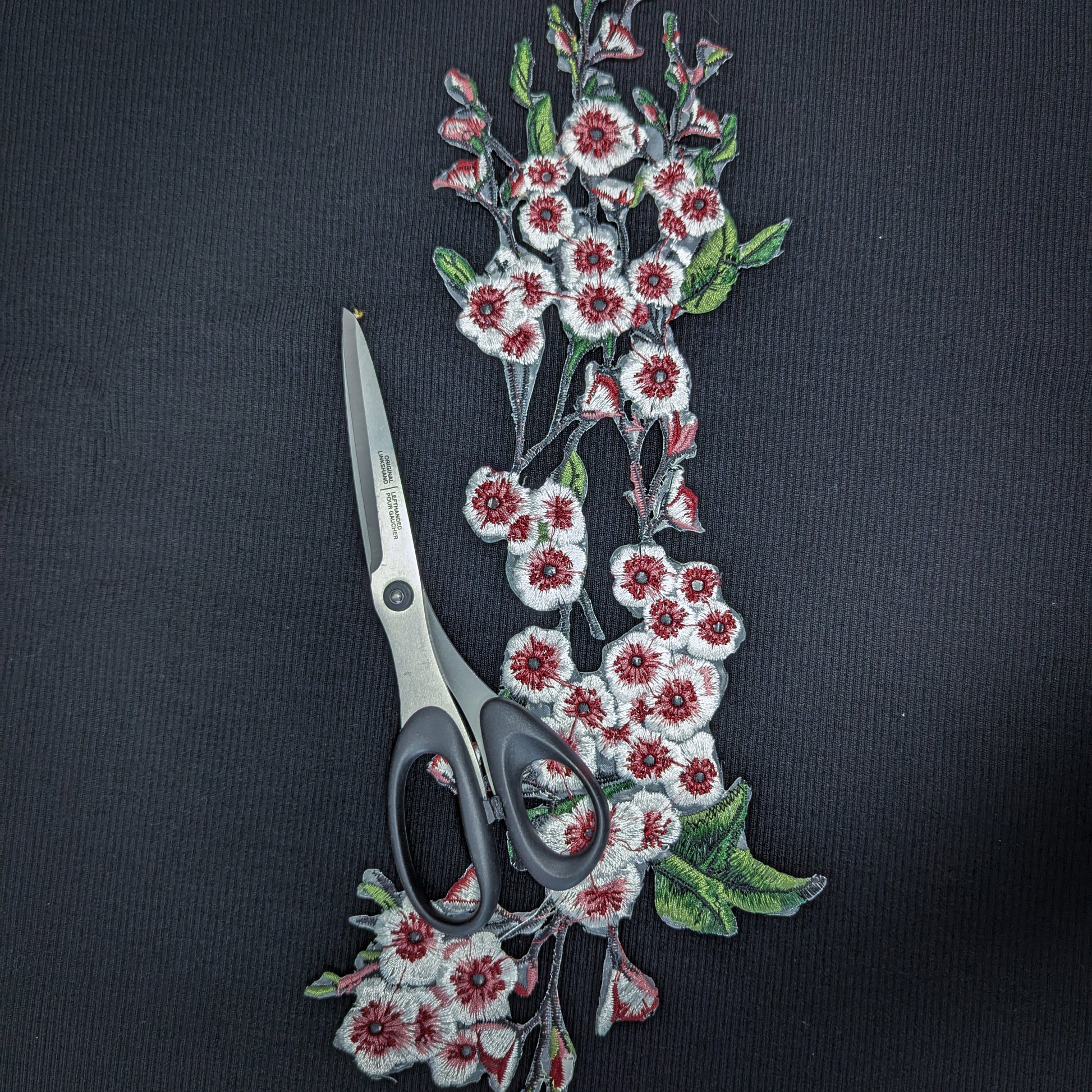 XXL G*cci knitted cherry blossom patch, 40cm, with red, white, and green embroidery on black fabric, beside scissors.