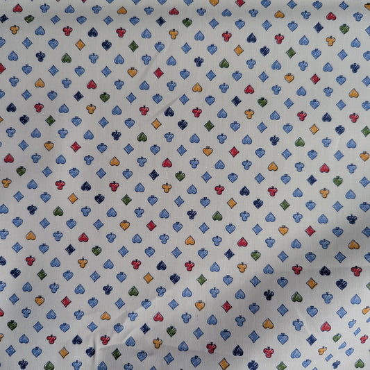 White cotton poplin fabric with small, colorful playing card suit pattern.