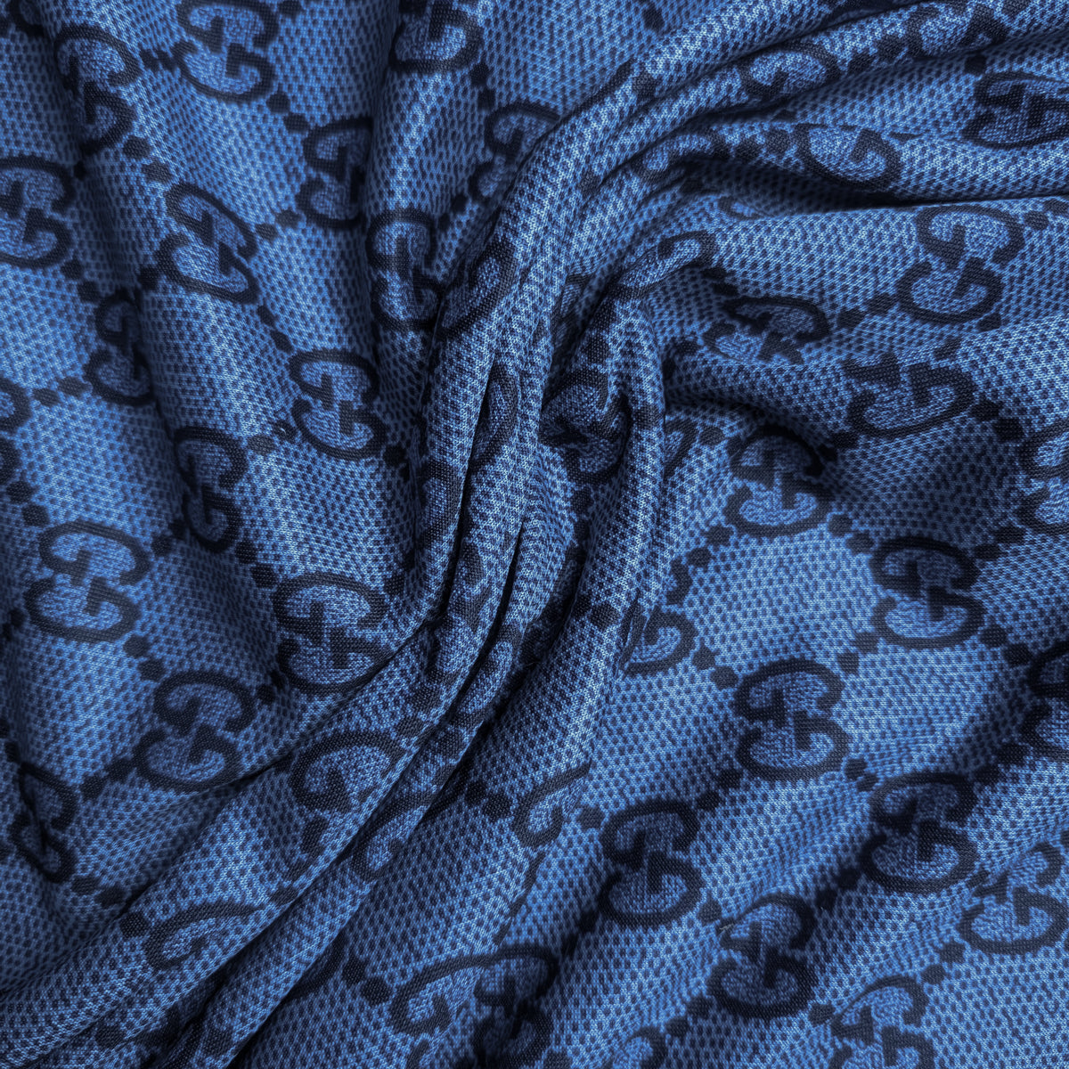 Blue Punto Milano deadstock fabric with dark designer monogram pattern and subtle texture.