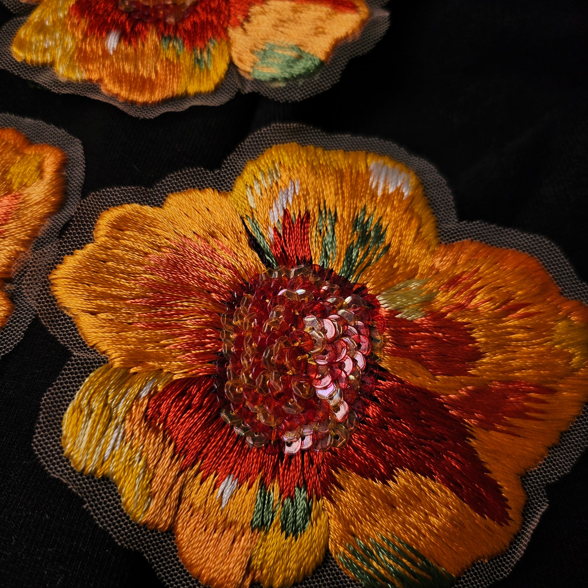 Hand-embroidered D&G floral patch, 7x9cm, with yellow, orange, red threads and iridescent sequins.