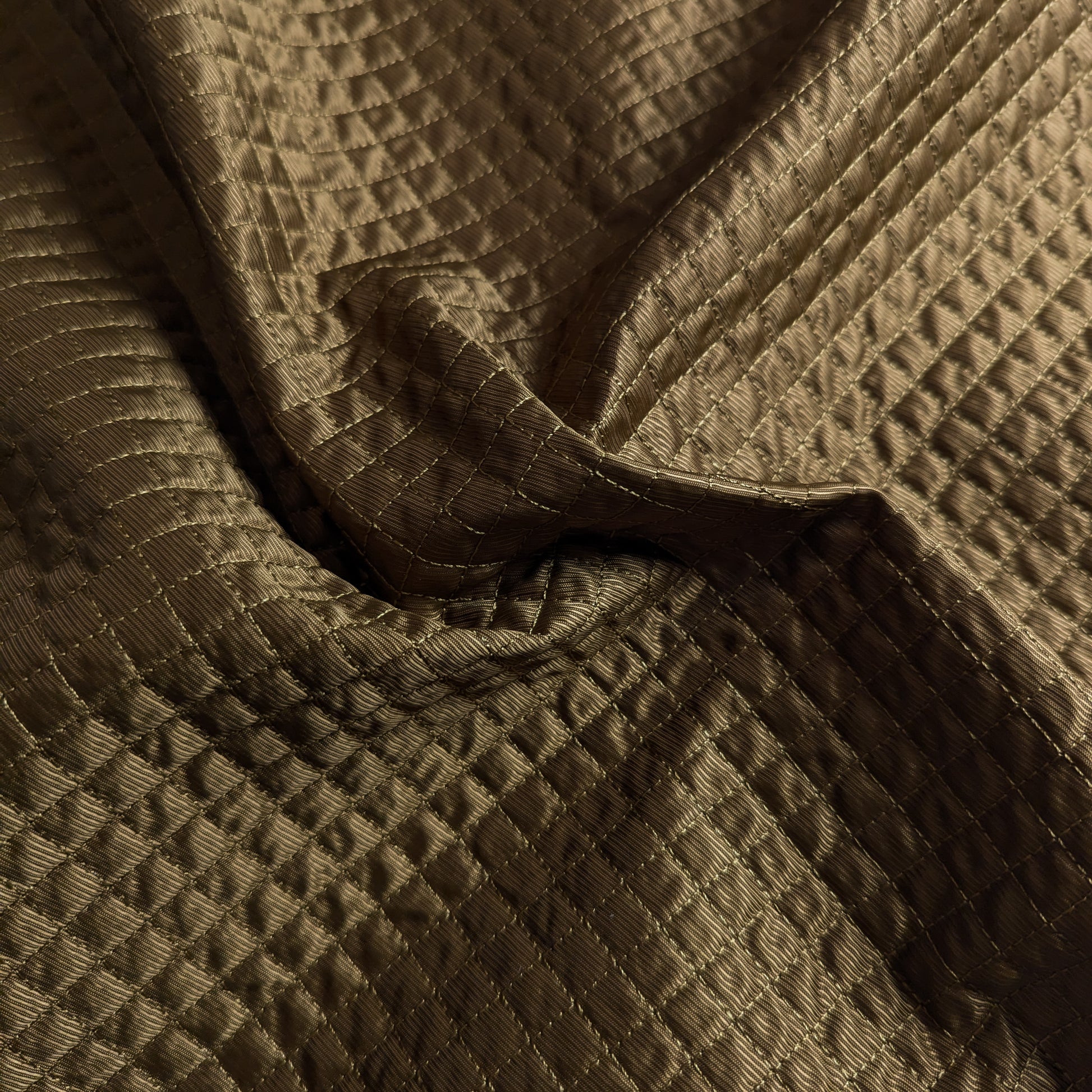 Olive G*cci deadstock quilted fabric, lightly padded with a matte, structured surface.