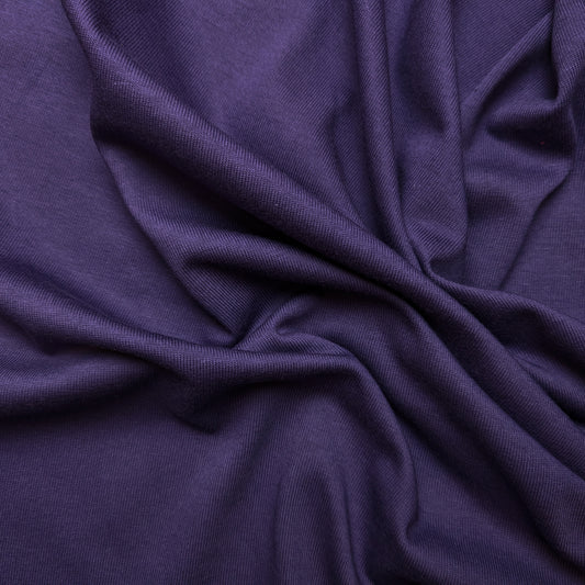 Wrinkled dark purple Pr*da deadstock jersey fabric, soft and flowing, showing its luxurious drape.