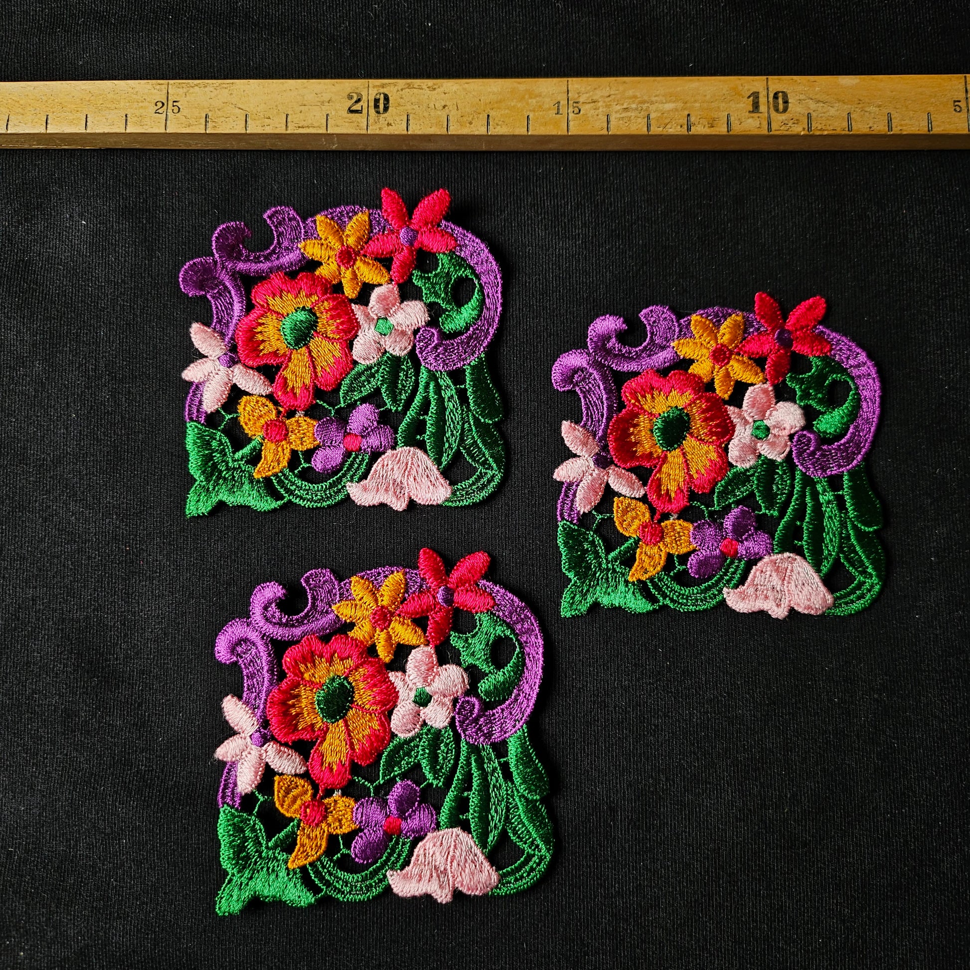 Three colorful embroidered floral patches, 8x8cm, with pink, orange, green, and purple threads.