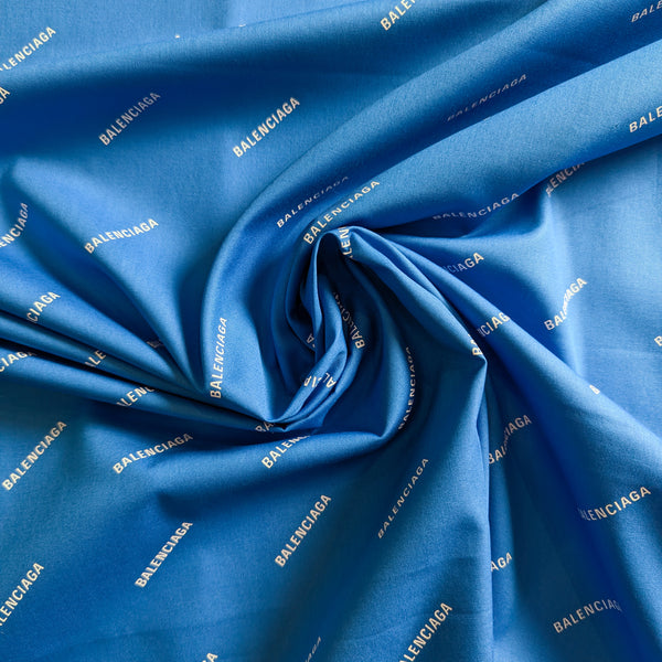 Deadstock Balenciaga cotton poplin fabric, Pantone blue with white logo print, 145 cm wide.