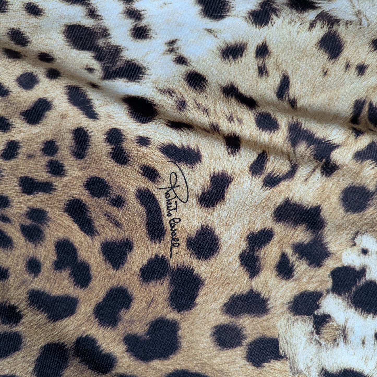 Elastic C*avalli deadstock Lycra fabric with natural leopard print, tan, brown, black spots, and signature logo.