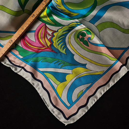 Pucci silk twill scarf, 90x90cm, with vibrant white, pink, green, blue, and yellow abstract pattern.