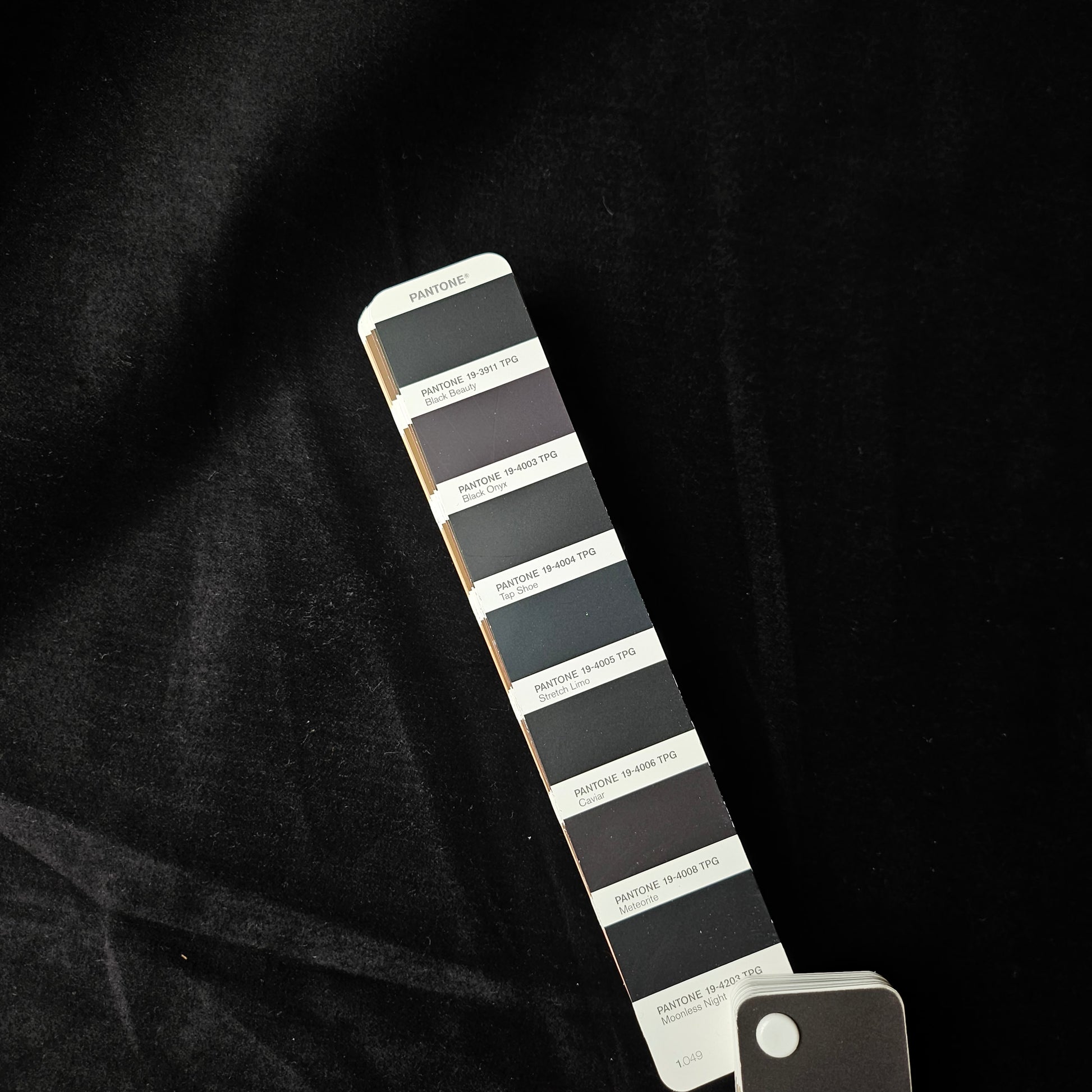 Deadstock G*cci velvet denim fabric in Pantone Moonless Night, shown with a color swatch.