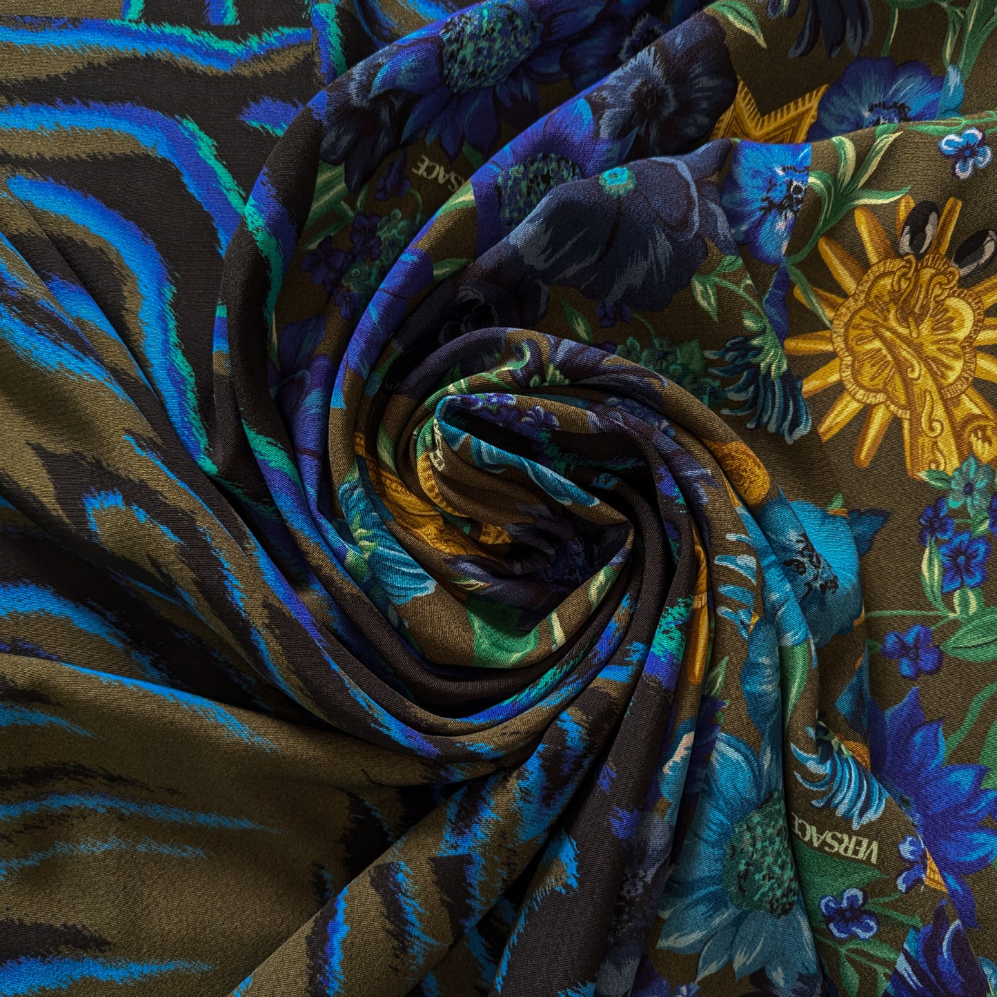 Versace deadstock viscose crepe panel with blue floral and tiger stripe patterns on an olive background.