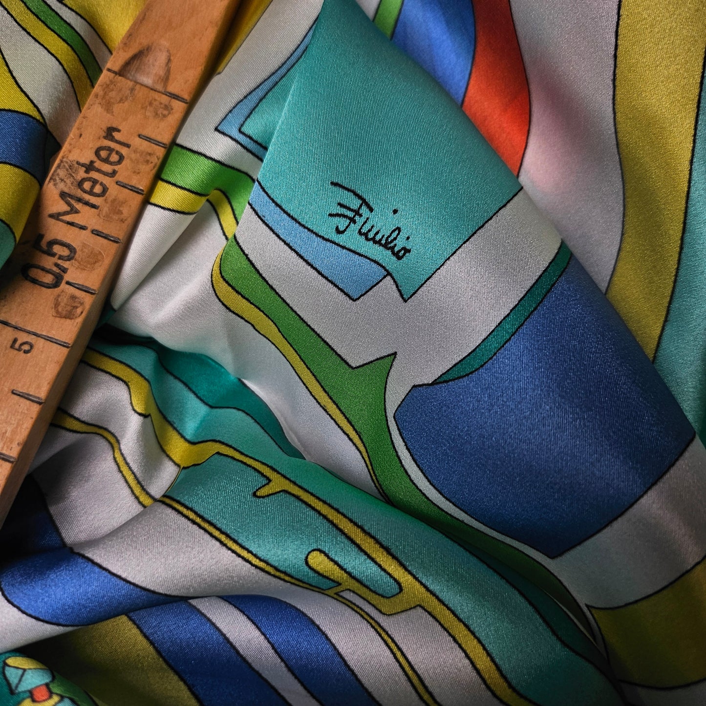 Pucci turquoise, blue, white, orange, beige twill silk scarf with geometric design and wooden ruler.