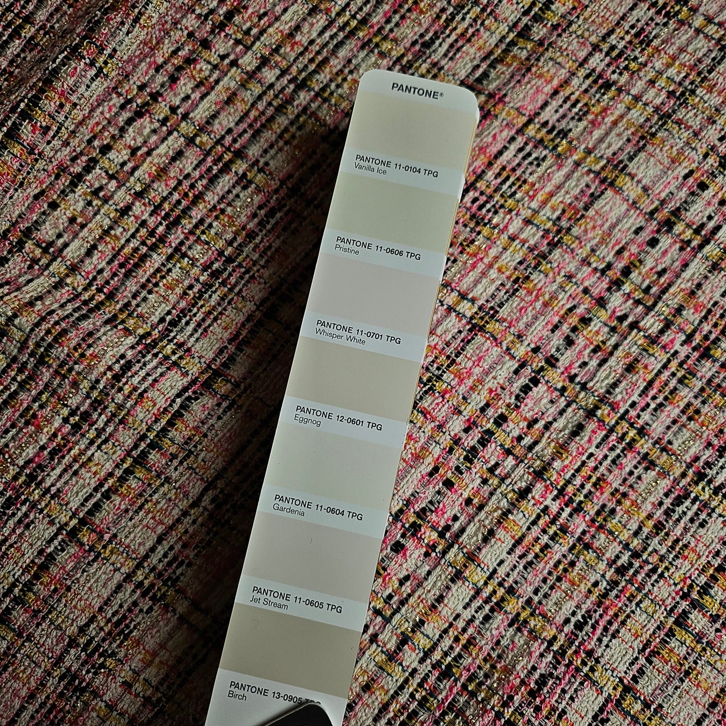 Tweed cotton blend fabric in Whisper White, pink, neon yellow, and black with Lurex, shown with a Pantone swatch.