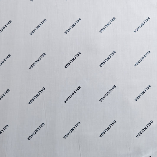 White Balenciaga deadstock cotton poplin fabric with repeated black logo print.